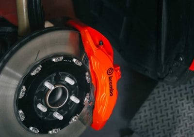 Close-up view of a freshly painted brake caliper, showcasing the vibrant color and premium finish.