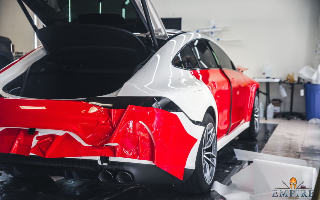 Image of a red car with paint protection film applied to the hood. The film is clear and transparent, and it protects the car's paint from scratches, chips, and other damage.