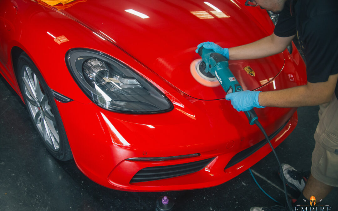 Empire Auto Spa technician using advanced tools and techniques for modern car polishing and detailing.